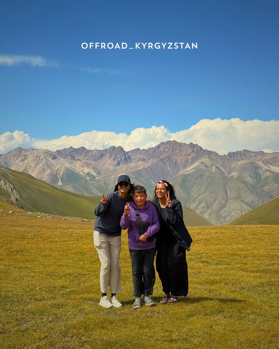 Singaporean guests meeting a local Kyrgyz shepherd boy on the high-altitude road to Son-Kul lake.