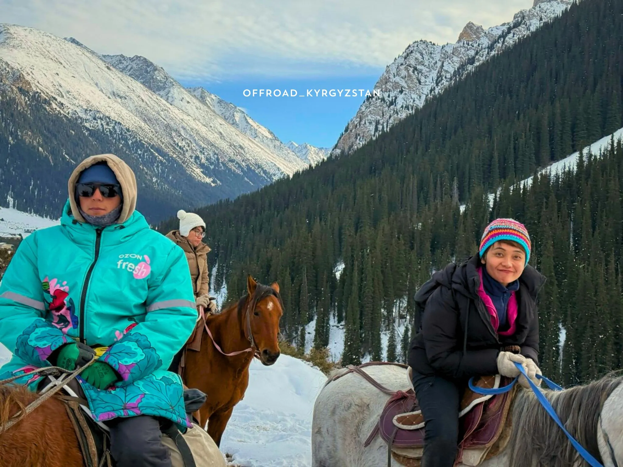 Indonesian tourists on a winter horseback trip to Altyn-Arashan hot springs, a signature Kyrgyzstan adventure tour.